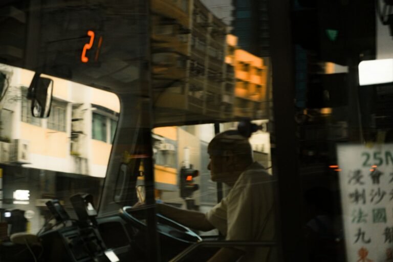 Asian bus driver looking tired and thoughtful behind the wheel, illustrating fatigue management for commercial drivers in Singapore