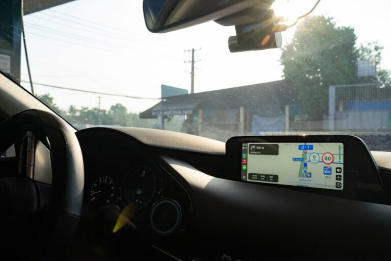 Driver viewing a GPS telematics screen inside a commercial vehicle cab, illustrating fleet tracking technology used by Singapore fleet operators