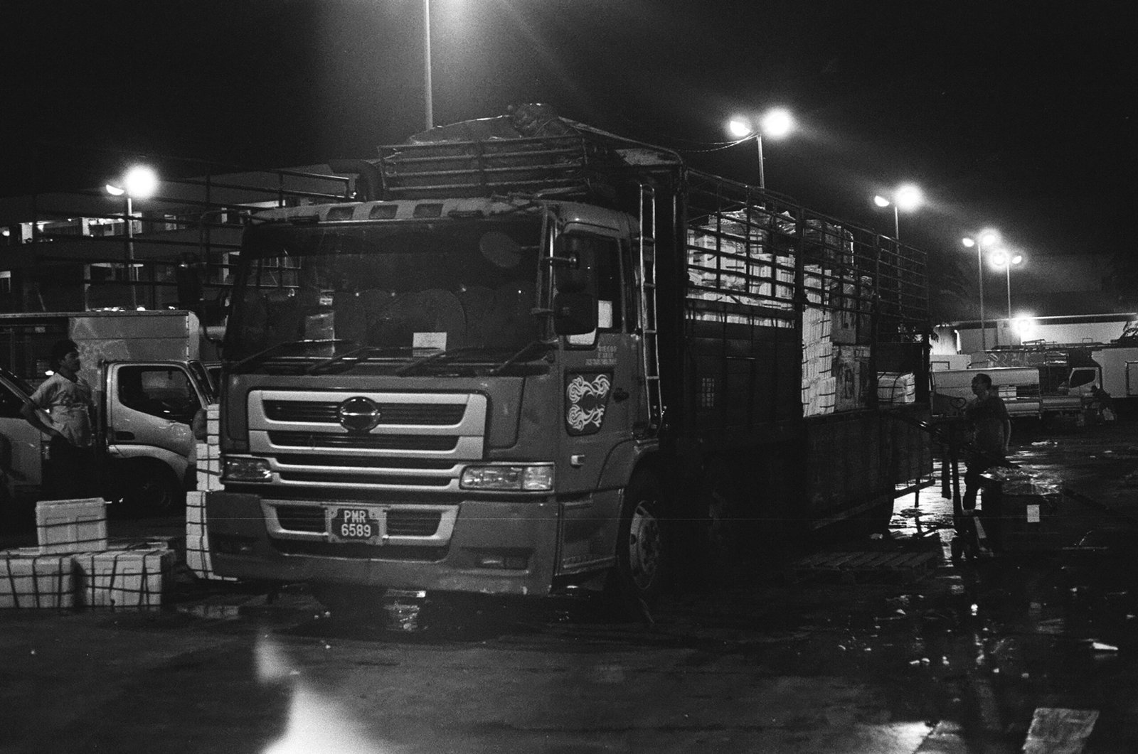 Cargo truck outside a Singapore warehouse loading bay, representing goods-in-transit exposure for freight and logistics operators