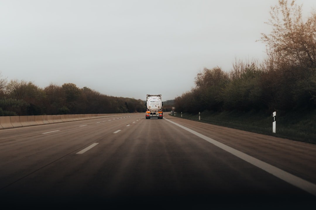 Commercial truck on the road, representing a fleet vehicle under an existing loan being considered for refinancing