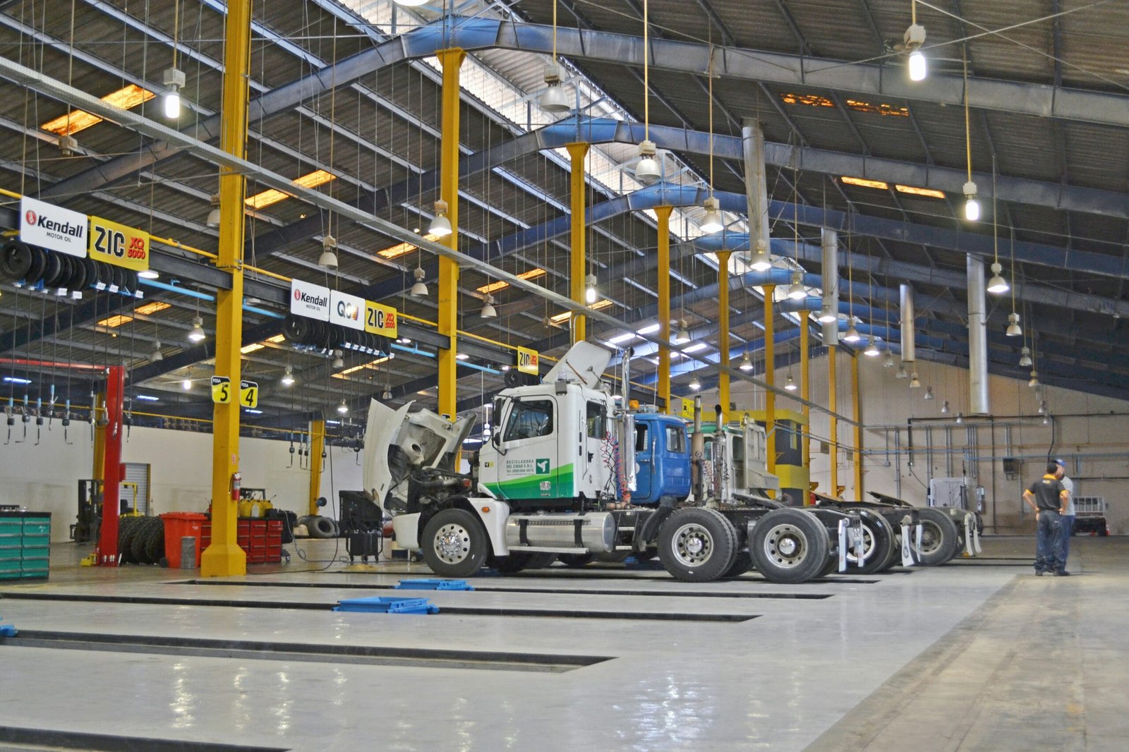 A commercial truck undergoing inspection inside a vehicle testing bay, similar to LTA-authorised inspection centres in Singapore