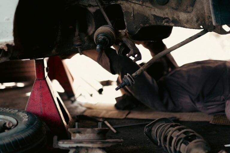 Mechanics working on a commercial vehicle in an automotive workshop, illustrating the LTA-approved modification and inspection process for Singapore commercial vehicles