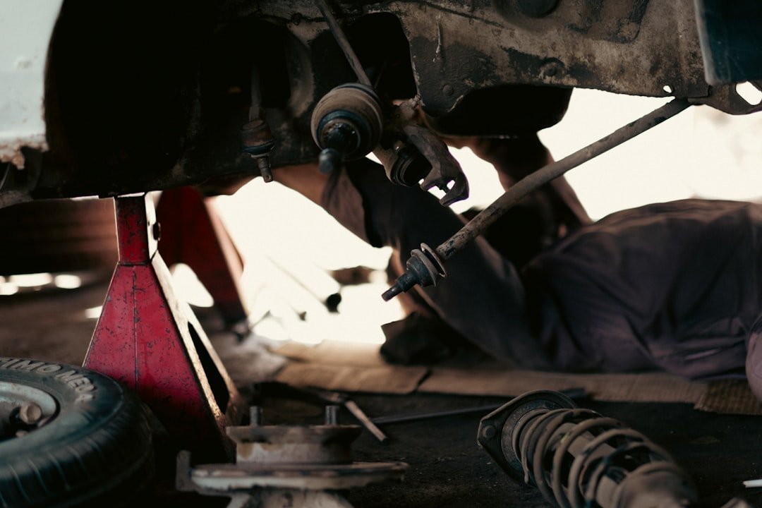 Mechanics working on a commercial vehicle in an automotive workshop, illustrating the LTA-approved modification and inspection process for Singapore commercial vehicles