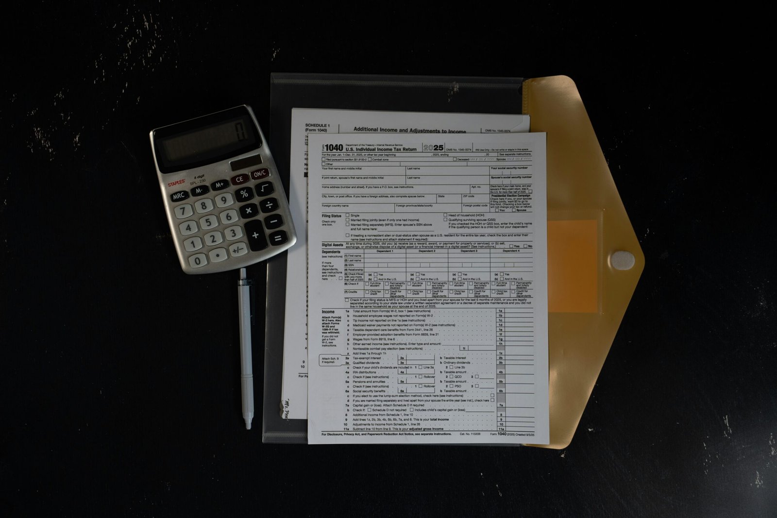 Calculator and insurance papers in a folder, representing the maths of comparing third-party versus comprehensive premiums on an older vehicle