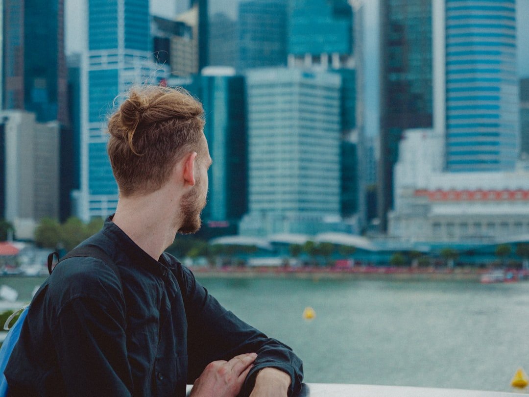 Person looking out over the Singapore skyline, representing a fleet manager budgeting against the current Category C COE premium