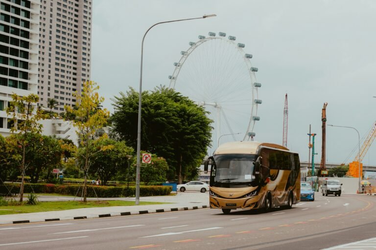 Electric bus travelling through a Singapore city street, symbolising the shift toward electric commercial fleets discussed in this EV vs diesel total cost of ownership comparison