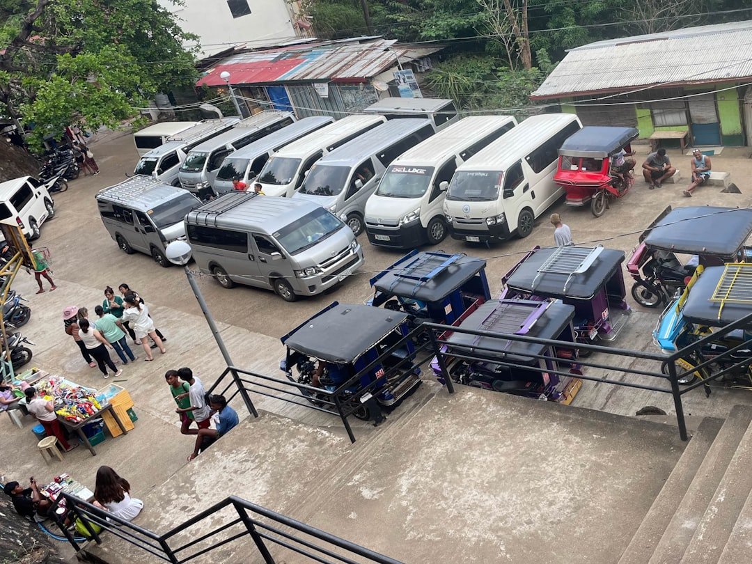 Rows of commercial vans and vehicles parked at a leasing company's fleet yard in Singapore