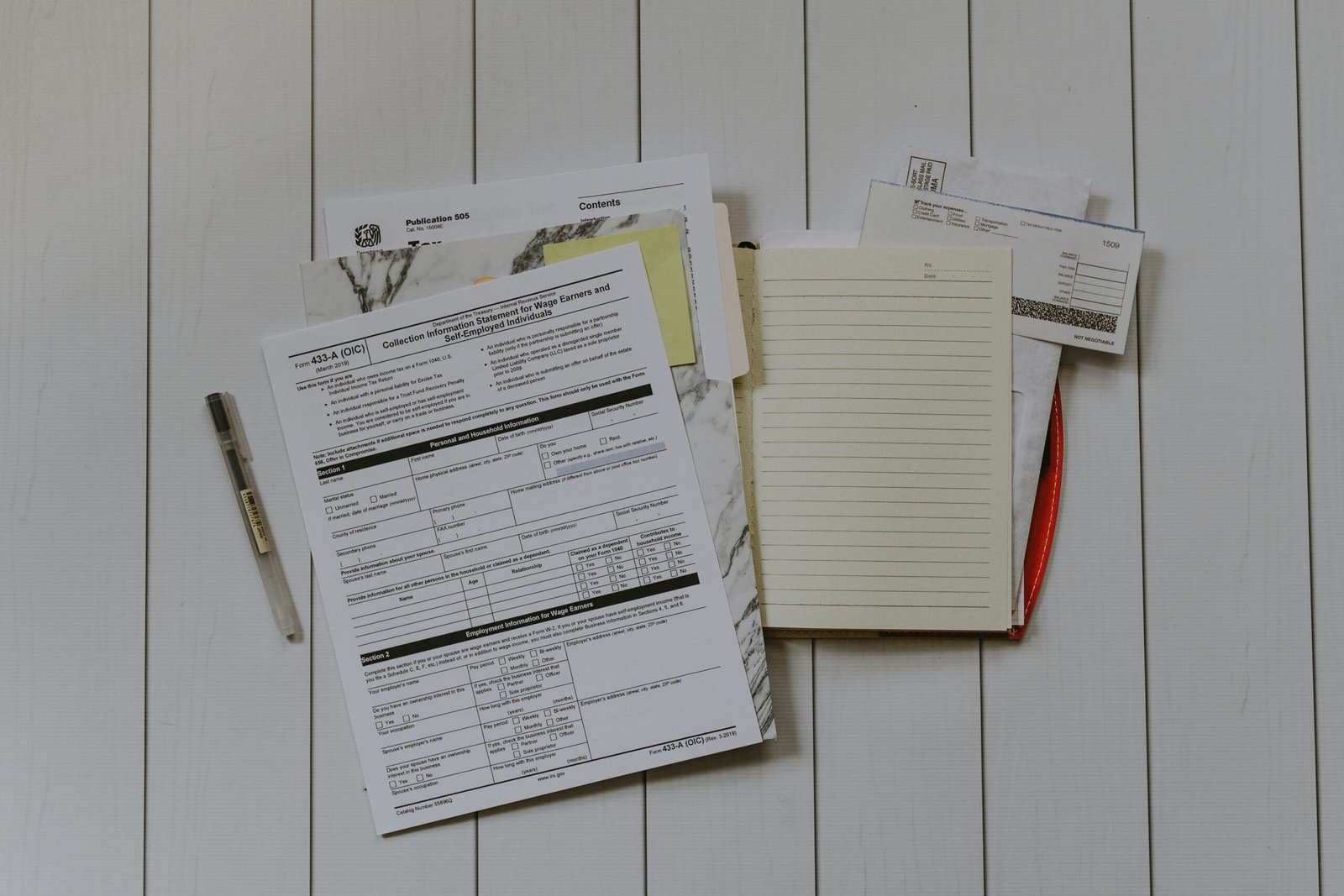 Stack of insurance claim documents and paperwork used when filing a goods-in-transit cargo claim in Singapore