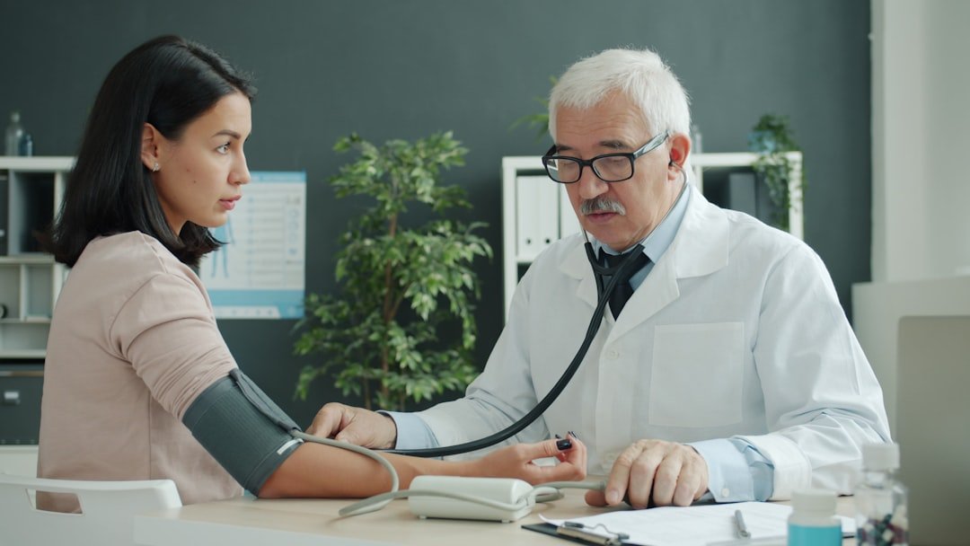 A doctor conducting a medical examination on a patient, relevant to Singapore's Harmonised Medical Examination Report requirements for vocational licence holders