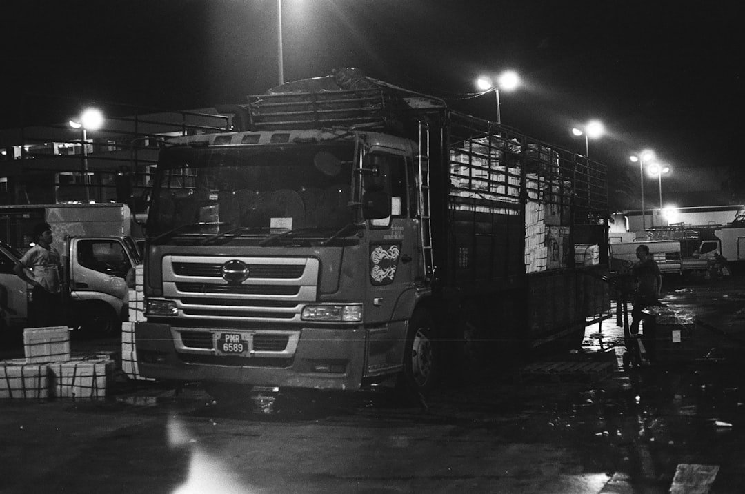 Heavy lorry truck on the road in front of a building, illustrating heavy vehicle turning and blind spot safety considerations