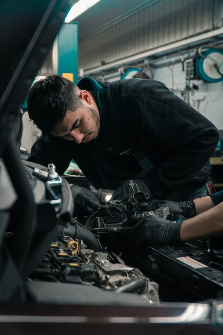 Mechanic inspecting a commercial vehicle engine as part of a pre-purchase checklist