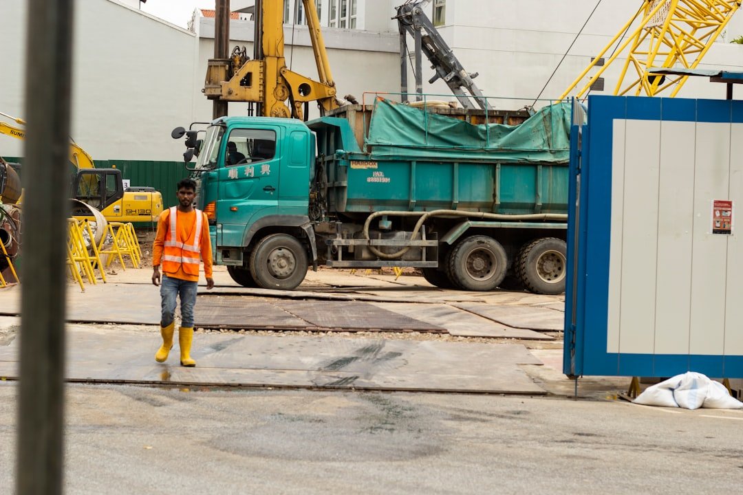 Heavy vehicles at an industrial estate in Singapore, illustrating the vehicle categories that require a Vehicle Parking Certificate