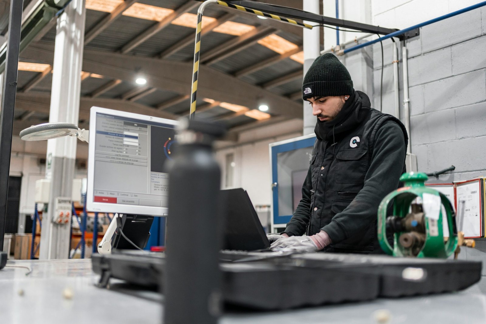 A technician using diagnostic software at a workshop workstation, representing the outsourced MRO option for commercial fleets